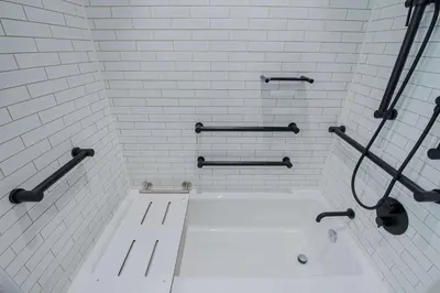 a white bathroom with a bath tub in a room at Canopy By Hilton Jersey City Arts District in Jersey City
