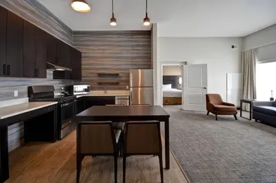 a kitchen and living room with a table and chairs at Residence Inn Middletown Goshen in Middletown