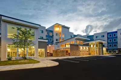 a row of buildings in a parking lot at Residence Inn Middletown Goshen in Middletown