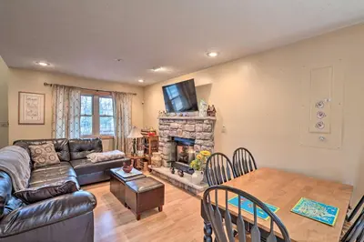 a living room with a couch and a fireplace at Walk to Pool and Lake Albrightsville Vacation Home! in Albrightsville