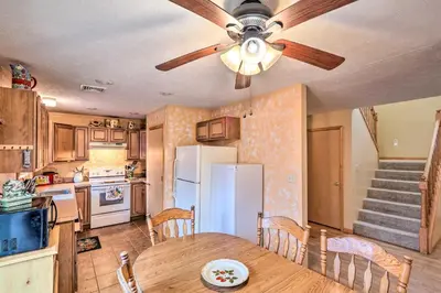 a kitchen with a table and a ceiling fan at Walk to Pool and Lake Albrightsville Vacation Home! in Albrightsville