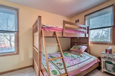 a bedroom with two bunk beds and two windows at Walk to Pool and Lake Albrightsville Vacation Home! in Albrightsville