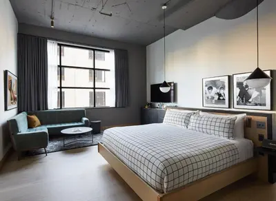 a bedroom with a bed and a couch and a chair at Fitler Club in Philadelphia