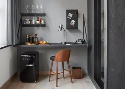 a kitchen with a counter and a stool next to a table at Fitler Club in Philadelphia