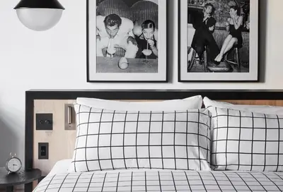 a bedroom with two framed pictures above a bed at Fitler Club in Philadelphia