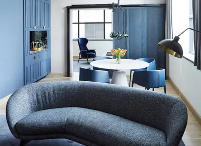 a living room with a couch and a table and chairs at Fitler Club in Philadelphia