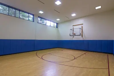 an empty gym with a basketball hoop in a room at Crowne Plaza Princeton - Conference Center by IHG in Princeton