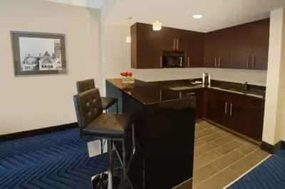 a kitchen with a counter and a chair in it at Crowne Plaza Princeton - Conference Center by IHG in Princeton