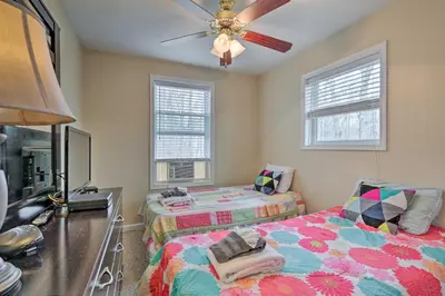 a bedroom with two beds and a ceiling fan at 6 Mi to Skiing Family Poconos Home w Decks! in Albrightsville