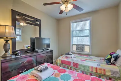 a bedroom with two beds and a mirror and a tv at 6 Mi to Skiing Family Poconos Home w Decks! in Albrightsville