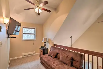 a living room with a couch and a ceiling fan at 6 Mi to Skiing Family Poconos Home w Decks! in Albrightsville
