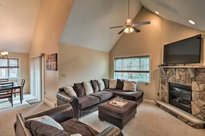 a living room with a couch and a flat screen tv at 6 Mi to Skiing Family Poconos Home w Decks! in Albrightsville