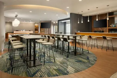 a lobby with a bar with stools at SpringHill Suites by Marriott Voorhees Mt. Laurel/Cherry Hill in Voorhees
