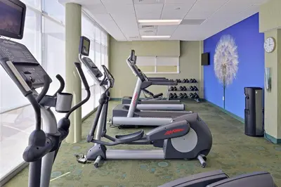 a gym with several cardio machines in a room at SpringHill Suites by Marriott Voorhees Mt. Laurel/Cherry Hill in Voorhees