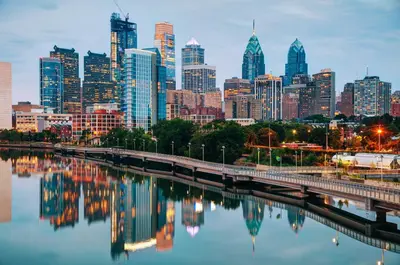 a city skyline with a river and a bridge at Abode XS House Stunning Architectural Flat in Philadelphia