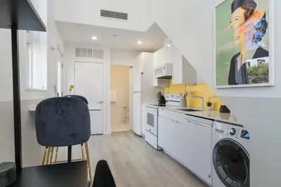 a kitchen with a washer and a washing machine at Abode XS House Stunning Architectural Flat in Philadelphia