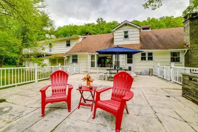 two red chairs and a table on a patio at Serene Home with On-Site Brook in Callicoon Center in Callicoon Center