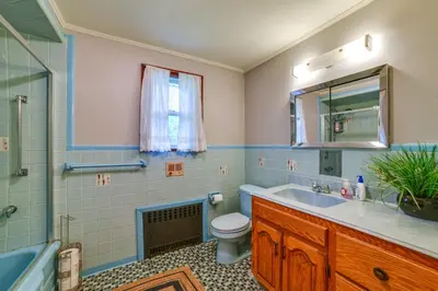 a bathroom with a sink and a toilet and a mirror at Serene Home with On-Site Brook in Callicoon Center in Callicoon Center