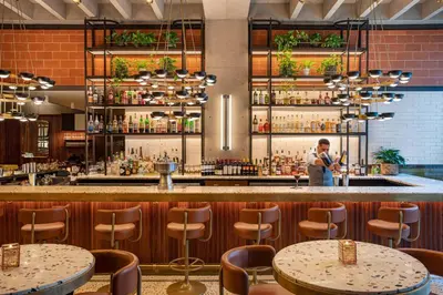 a man standing at a bar in a restaurant at Element Philadelphia Downtown in Philadelphia