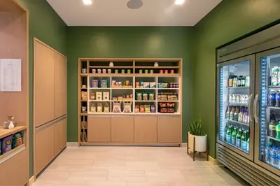 a pharmacy aisle with green walls at Element Philadelphia Downtown in Philadelphia