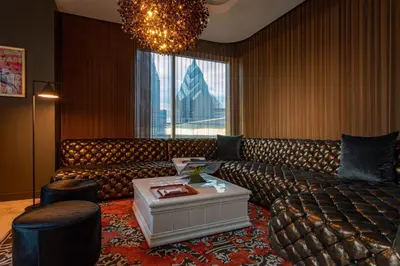 a living room with a couch and a large window at W Philadelphia in Philadelphia
