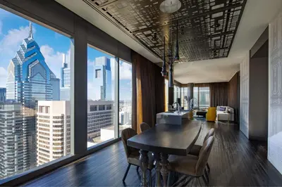 a dining room with a view of a skyscraper at W Philadelphia in Philadelphia