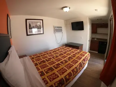 a hotel room with a bed and a television at Rest Inn - Elizabeth in Elizabeth