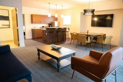 a living room and kitchen with a couch and a table at Courtyard by Marriott Philadelphia Springfield in Springfield