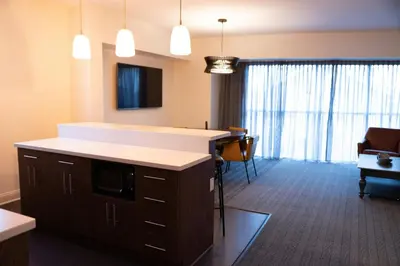 a room with a kitchen with a counter and a living room at Courtyard by Marriott Philadelphia Springfield in Springfield