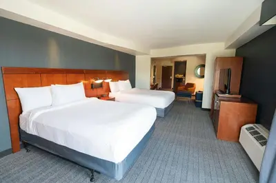 a hotel room with two beds and a television at Courtyard by Marriott Philadelphia Springfield in Springfield