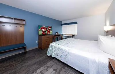 a hotel room with a bed and a television at HomeTowne Studios by Red Roof Wilmington - New Castle in New Castle