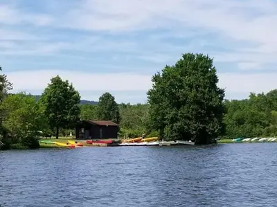 a lake with a group of boats on the shore at Tru By Hilton Grantville, Pa in Grantville