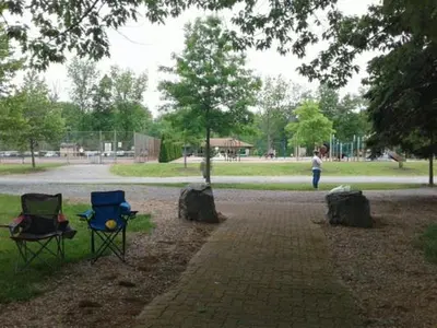 two chairs sitting on a brick path in a park at Tru By Hilton Grantville, Pa in Grantville