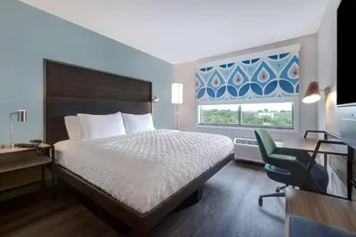 a hotel room with a bed and a desk and a chair at Tru By Hilton Grantville, Pa in Grantville