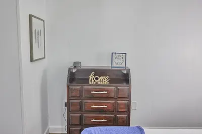 a dresser with a sign on it in a room at Fairway Paradise tiny home in Lancaster