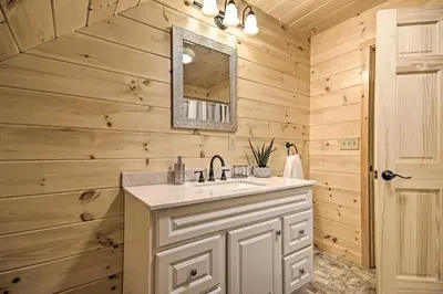 a bathroom with a sink and a mirror at Lake View and Hot Tub Wrightsville Cabin! in Wrightsville