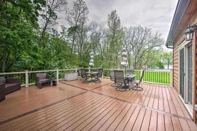 a wooden deck with a table and chairs on it at Lake View and Hot Tub Wrightsville Cabin! in Wrightsville