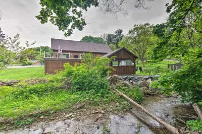 an image of a house from the river at Lake View and Hot Tub Wrightsville Cabin! in Wrightsville