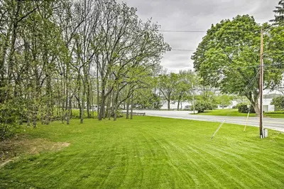 a grassy yard with trees and a road at Lake View and Hot Tub Wrightsville Cabin! in Wrightsville