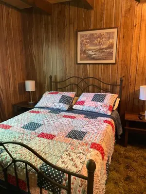 a bedroom with a bed with a quilt on it at Saw Creek Cabin - Regent Hilltop in Bushkill