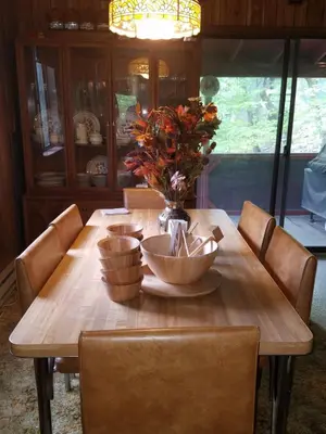 a wooden table with a vase of flowers on it at Saw Creek Cabin - Regent Hilltop in Bushkill