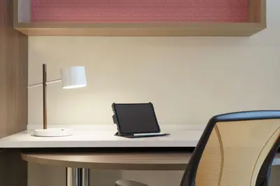 a laptop sitting on a desk with a lamp at Home2 Suites By Hilton Ephrata in Ephrata