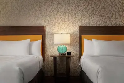 a hotel room with two beds and a table with a lamp at Home2 Suites By Hilton Ephrata in Ephrata