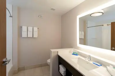 a bathroom with a sink and a mirror at Holiday Inn Express & Suites - Harrisburg S - Mechanicsburg by IHG in Mechanicsburg