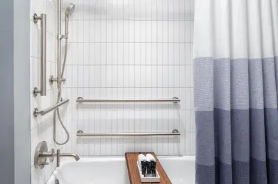a bathroom with a tub and a shower curtain at Hyatt Centric Rittenhouse Square Philadelphia in Philadelphia