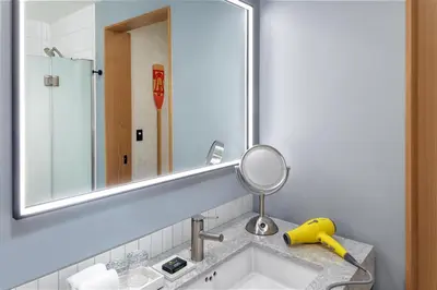 a bathroom with a sink and a mirror at Hyatt Centric Rittenhouse Square Philadelphia in Philadelphia