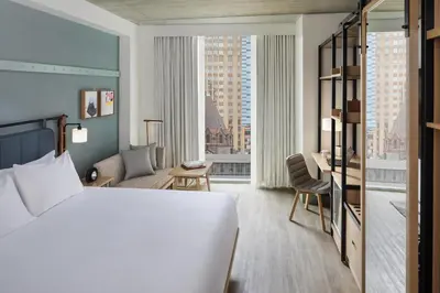a hotel room with a bed and a large window at Hyatt Centric Rittenhouse Square Philadelphia in Philadelphia