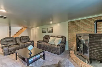 a living room with two couches and a fireplace at The Millersburg Mountain House Getaway with Gazebo! in Millersburg