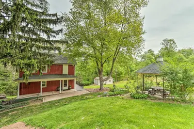 a red house with a gazebo in a yard at The Millersburg Mountain House Getaway with Gazebo! in Millersburg