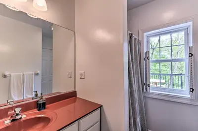 a bathroom with a sink and a mirror and a window at The Millersburg Mountain House Getaway with Gazebo! in Millersburg